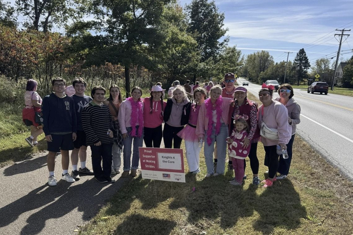 Rice students and staff stop to pose with their sign “Knights for the Cure” halfway through the 3-mile walk.